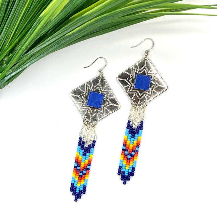 Diamond shaped silver concho with blue, orange, yellow and red dangling bead work on fishhooks