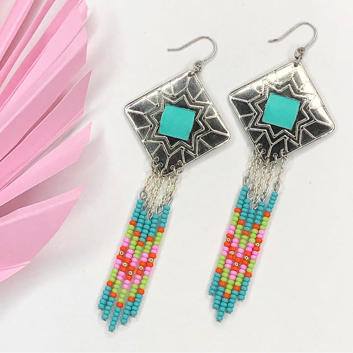 Diamond shaped silver concho with Turquoise, green, pink and orange dangling bead work on fishhooks