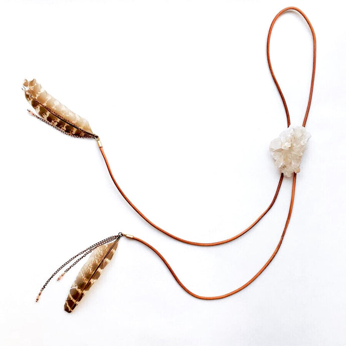 Quartz Crystal Bolo Tie on cognac brown leather cord finished at the ends with feathers and chain detailing