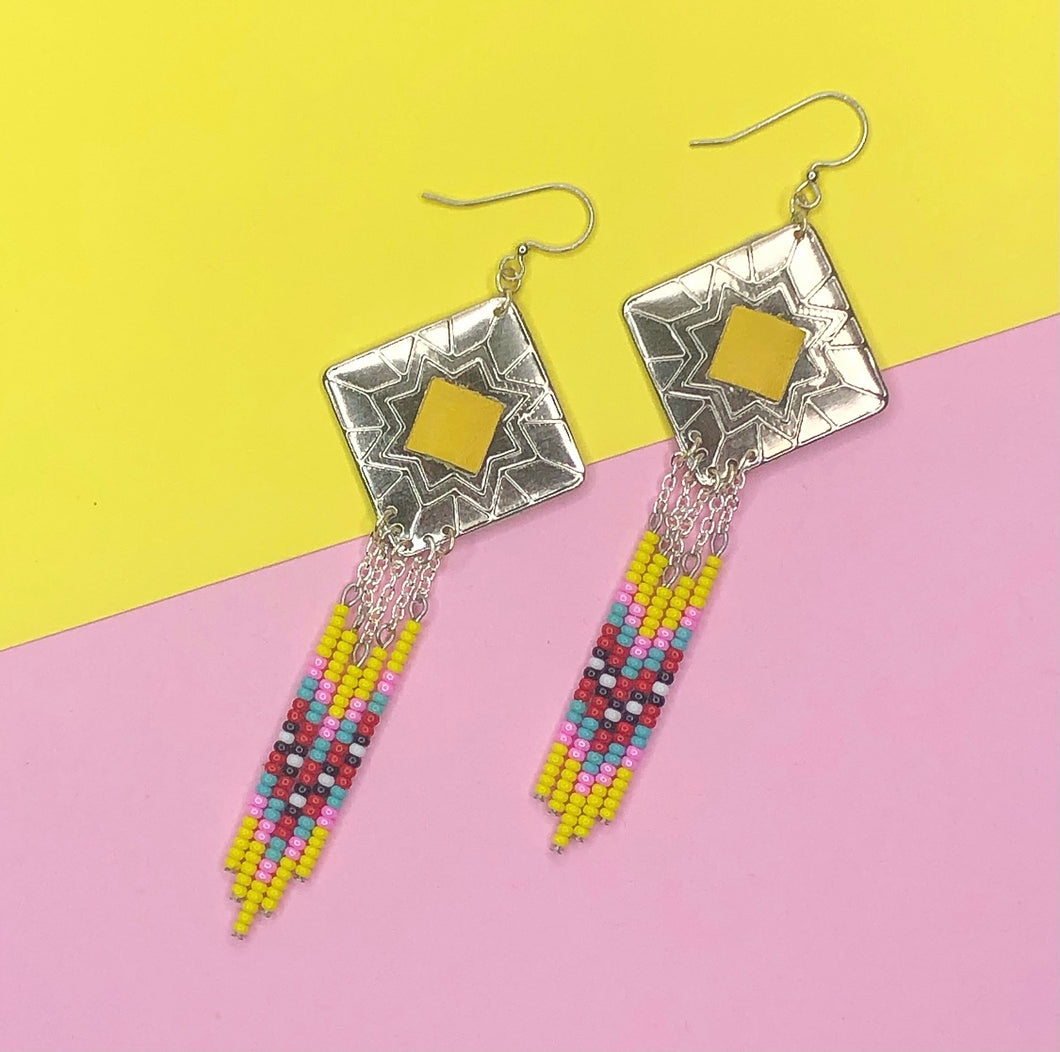 Diamond shaped silver concho with yellow, pink, turquoise and red dangling bead work on fishhooks