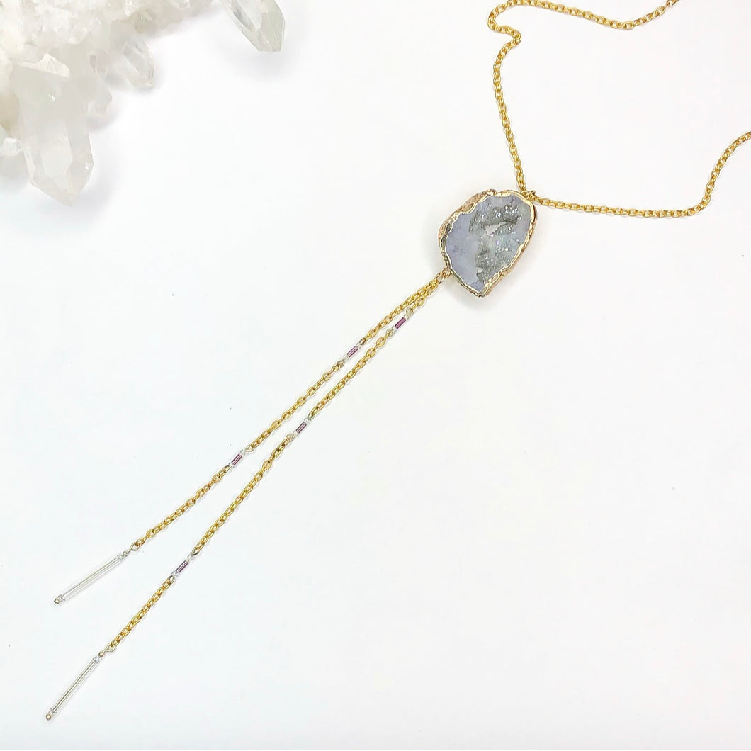 Gold Geode Necklace with beaded accents and two long chain drop from the geode